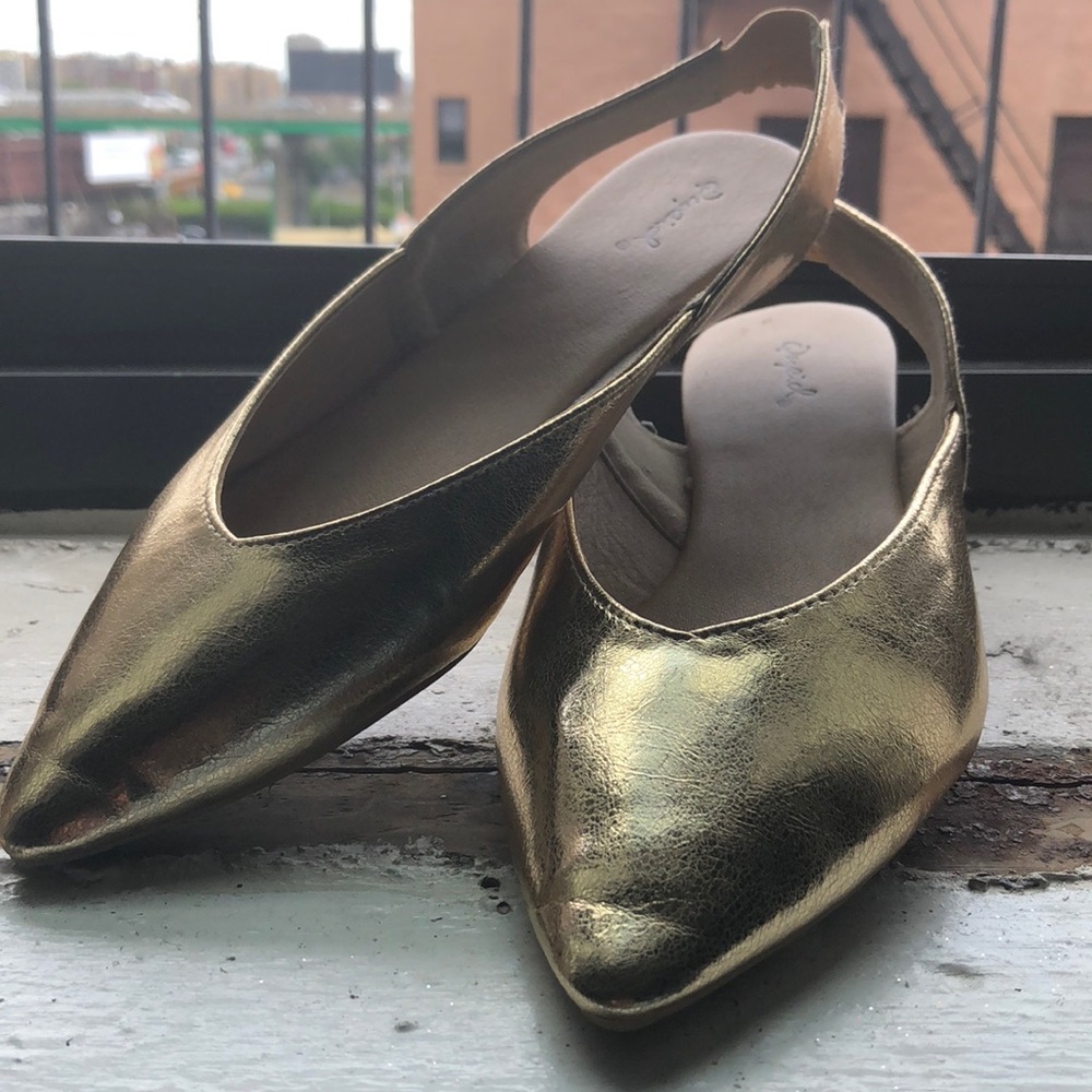 Gold pointed toe flats with open back